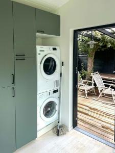 a washer and dryer in a room with a patio at Stylish House Between Beach And Forest In Tisvilde in Tisvilde