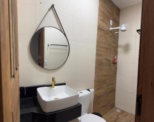 a bathroom with a white sink and a mirror at Aconchego em Piranhas in Piranhas +6 photos