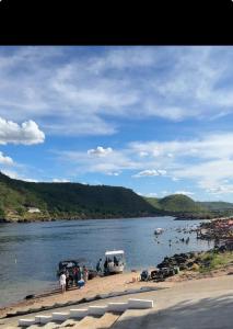 a group of people on the shore of a river at Aconchego em Piranhas in Piranhas