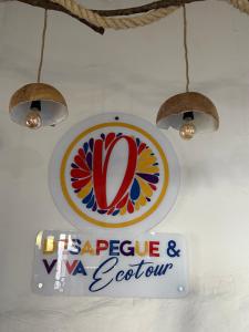 a sign on a wall with a sign for a restaurant at Desapegue & Viva Bed and Bikes in Ilhéus