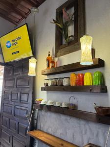 a door in a room with colorful objects on the wall at Desapegue & Viva Bed and Bikes in Ilhéus