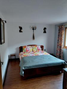 a bedroom with a bed and a cross on the wall at Cabana Țibleș Bichigiu in Bichigiu +12 photos