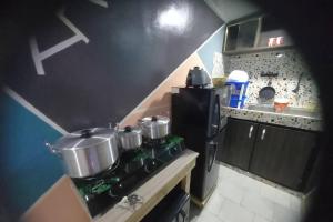 a kitchen with pots and pans on a stove at Apartment-Sleeps2-Parking-PetFriendly in Locodjo +5 photos