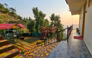 a balcony of a house with a view of the ocean at HILL MOUNT Cabin Home in Chamba