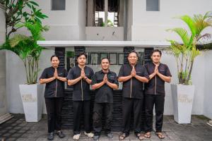 a group of men standing in front of a building at Villa Kubu Pratiwi - Villa 2 in Canggu