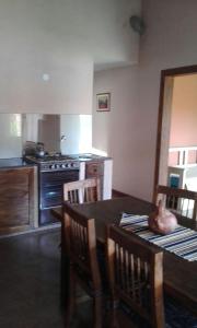 a kitchen with a wooden table and a kitchen with a stove at La Casita de Sil in Mina Clavero
