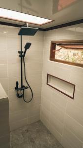 a shower in a bathroom with a shower head at Jati Rinjani Tetebatu in Tetebatu +41 photos