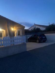 a car parked in front of a house at Le redful in Étoile-sur-Rhône