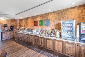 a kitchen with wooden cabinets and a counter at Comfort Inn - Gander in Gander