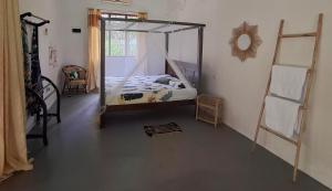 a bedroom with a bed with a canopy at Sansayin Homestay in Hambantota