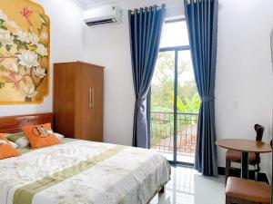 a bedroom with a bed and a window and a table at Hue Lotus Homestay in Hue +87 photos