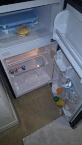 an open refrigerator with its door open and drinks inside at NO DAY OF BOOKING 24 HOURS NOTICE One private Master Efficency Suite Room with Bathroom for one person or couple with a pool breakfast included message here or email Floridastylz74 g mail com in Davenport