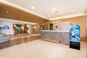 a lobby of a hotel with a reception desk at Metland Hotel Bekasi in Bekasi