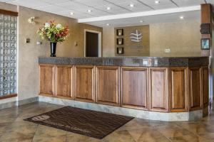 a lobby with a bar with a vase of flowers at Comfort Inn - Gander in Gander