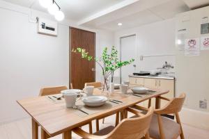 a dining room with a wooden table and chairs at Feel Stay NAGOYA in Nagoya +28 photos