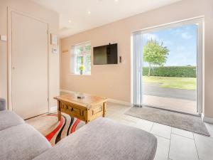 a living room with a couch and a table at Jemmett Lodge in Kent