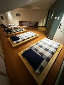a row of beds sitting in a room at Talna in Baguio