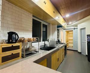 a large kitchen with a sink and a counter at Talna in Baguio