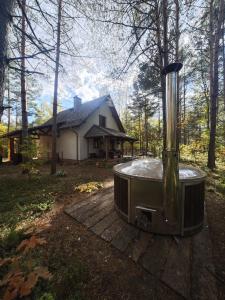 a hot tub sitting in front of a house at Leśny Relaks in Krasiejów