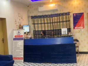a store front with a blue counter in a room at Glorious Guest House & Hotel in Multan +36 photos