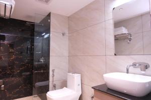 a bathroom with a toilet and a sink and a shower at Hotel The Royal Keshar-Near Bhutan Border in Jaigaon +40 photos