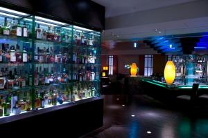 a bar filled with lots of bottles of alcohol at Sheraton Miyako Hotel Osaka in Osaka