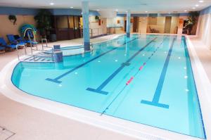 a swimming pool filled with lots of blue water at Hibernian Hotel & Leisure Centre in Mallow