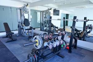 a gym with a lot of equipment in a room at Lumis Hotel Whitefield in Bangalore