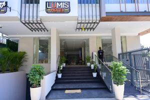 a man walking down the stairs of a building at Lumis Hotel Whitefield in Bangalore