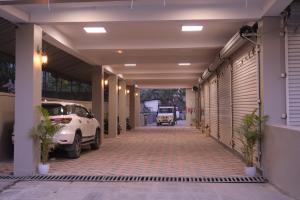 a garage with a car parked inside of a building at Hotel The Royal Keshar-Near Bhutan Border in Jaigaon