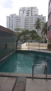 a swimming pool in a city with tall buildings at Flat na Boa Viagem Recife A in Recife