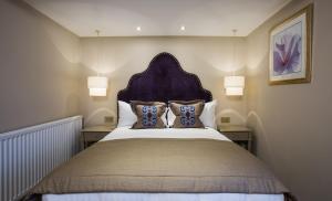 a bedroom with a bed and a painting on the wall at Arden House - Eden Hotel Collection in Stratford-upon-Avon