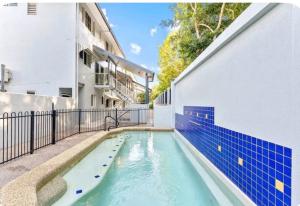 a swimming pool in the side of a building at Luxury Terrace Apartment in Trinity Beach