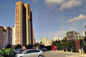 a parking lot with cars parked in front of tall buildings at Apartment Eva Mar in Benidorm