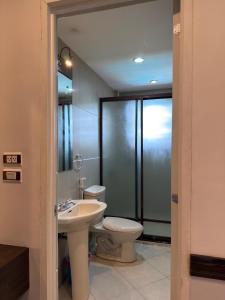 a bathroom with a toilet and a sink at Hotel Grand Luis in Dauis +41 photos