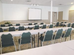 a conference room with tables and chairs and a whiteboard at Days Inn by Wyndham Georgetown in Georgetown