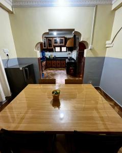 a wooden table with a bowl of fruit on top of it at Amelie Apartments and Stay Inn in Pokhara +18 photos