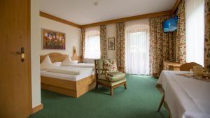 Postel nebo postele na pokoji v ubytování Hotel Garni Elisabeth