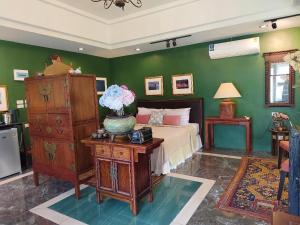 a bedroom with a bed and a table with a vase of flowers at Phu View Hideaway in Ban Kham Proi