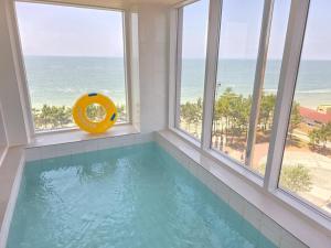 a swimming pool in a room with windows at 대천 아이오션 풀빌라 호텔 in Koryŏng +17 photos