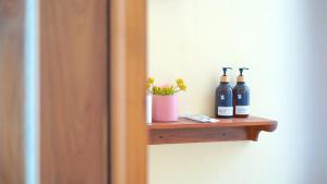 a shelf with bottles of wine and a plant at Among Villa Demangan in Yogyakarta +19 photos