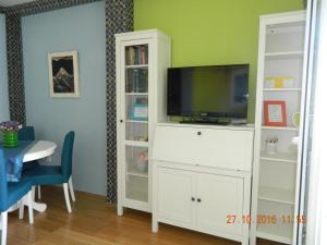 a white entertainment center with a flat screen tv at Apartment Dunja in Novi Sad