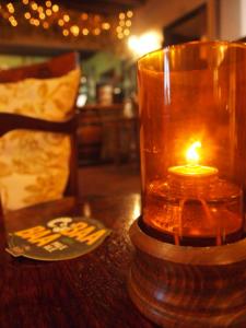 a candle sitting on a table next to a table sidx sidx sidx sidx at Black Swan Inn in Masham