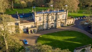 a large house with a car parked in front of it at The Old Lodge in Malton