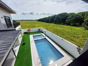 a swimming pool on the balcony of a house at Casa Marangle Private Villa in Mexico