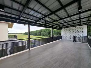 a large covered patio with a view of a field at Casa Marangle Private Villa in Mexico