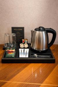 a tray with a tea kettle on a table at Urban Nest old Tbilisi hotel in Tbilisi City