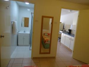 a room with a mirror and a kitchen with a bed at Hacienda Wayaca Apartments in Wayaca +32 photos
