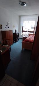 a bedroom with a bed and a desk and a window at Steffi in Hannover