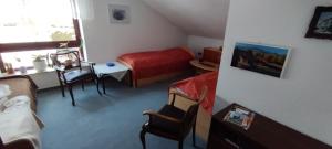 a bedroom with a bed and a table and chairs at Steffi in Hannover